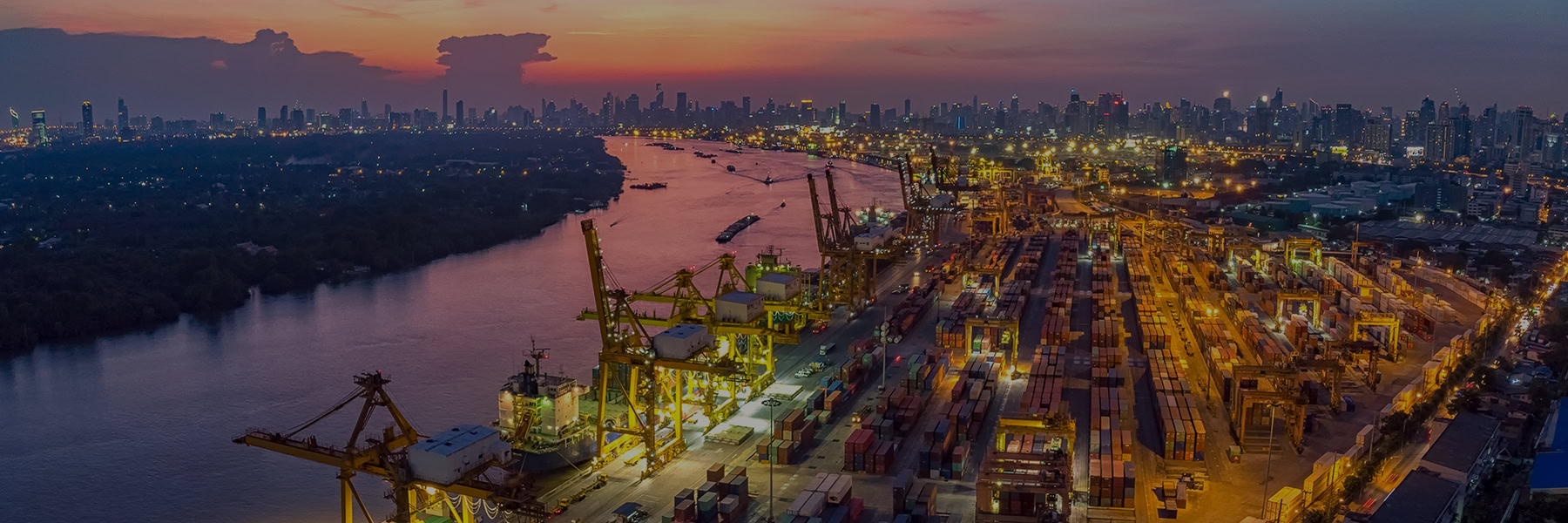 Loading dock on a river at night during sunset
