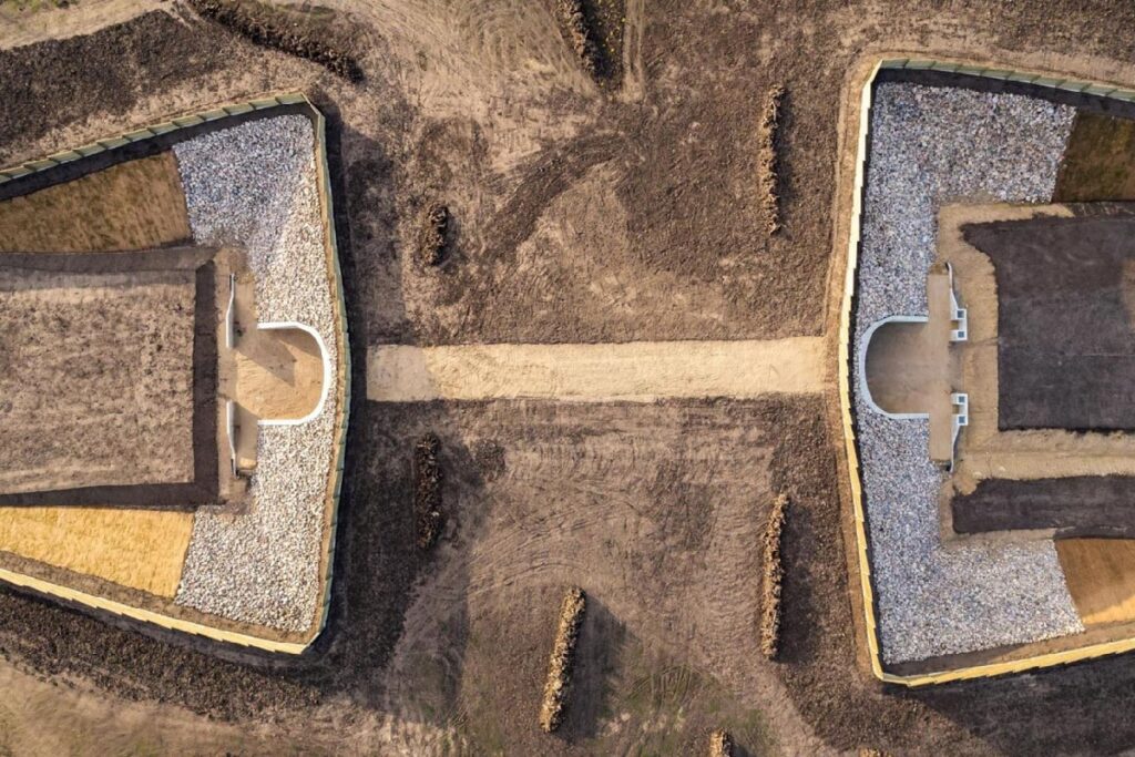 An aerial view of a building in the middle of a field.